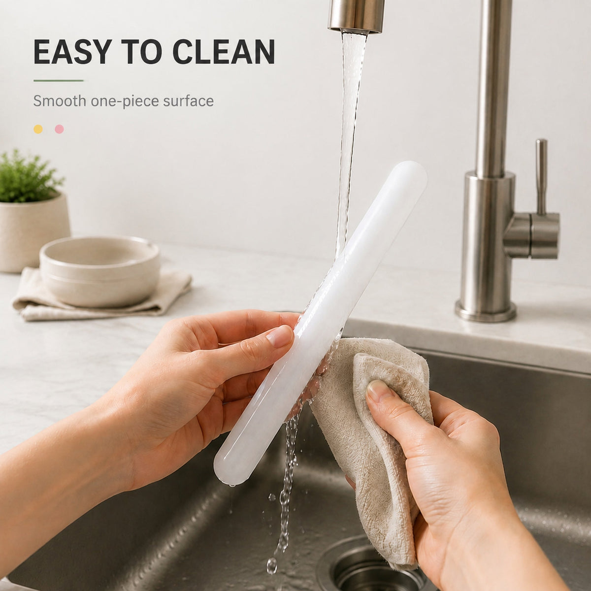 Plastic rolling pin being rinsed and wiped clean at a sink