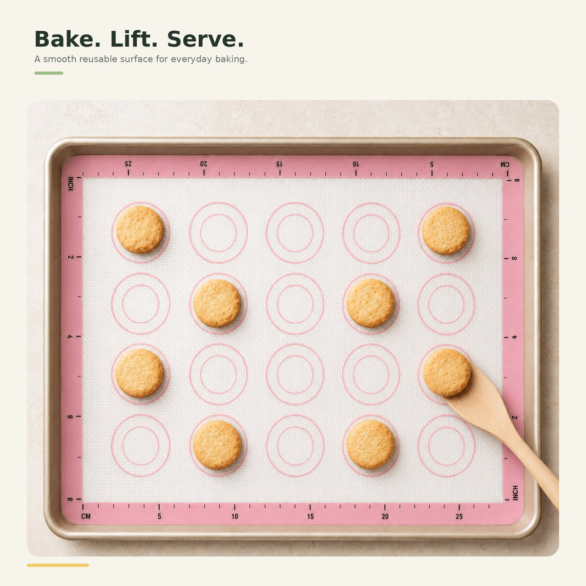 Silicone baking mat with baked cookies being lifted from the surface