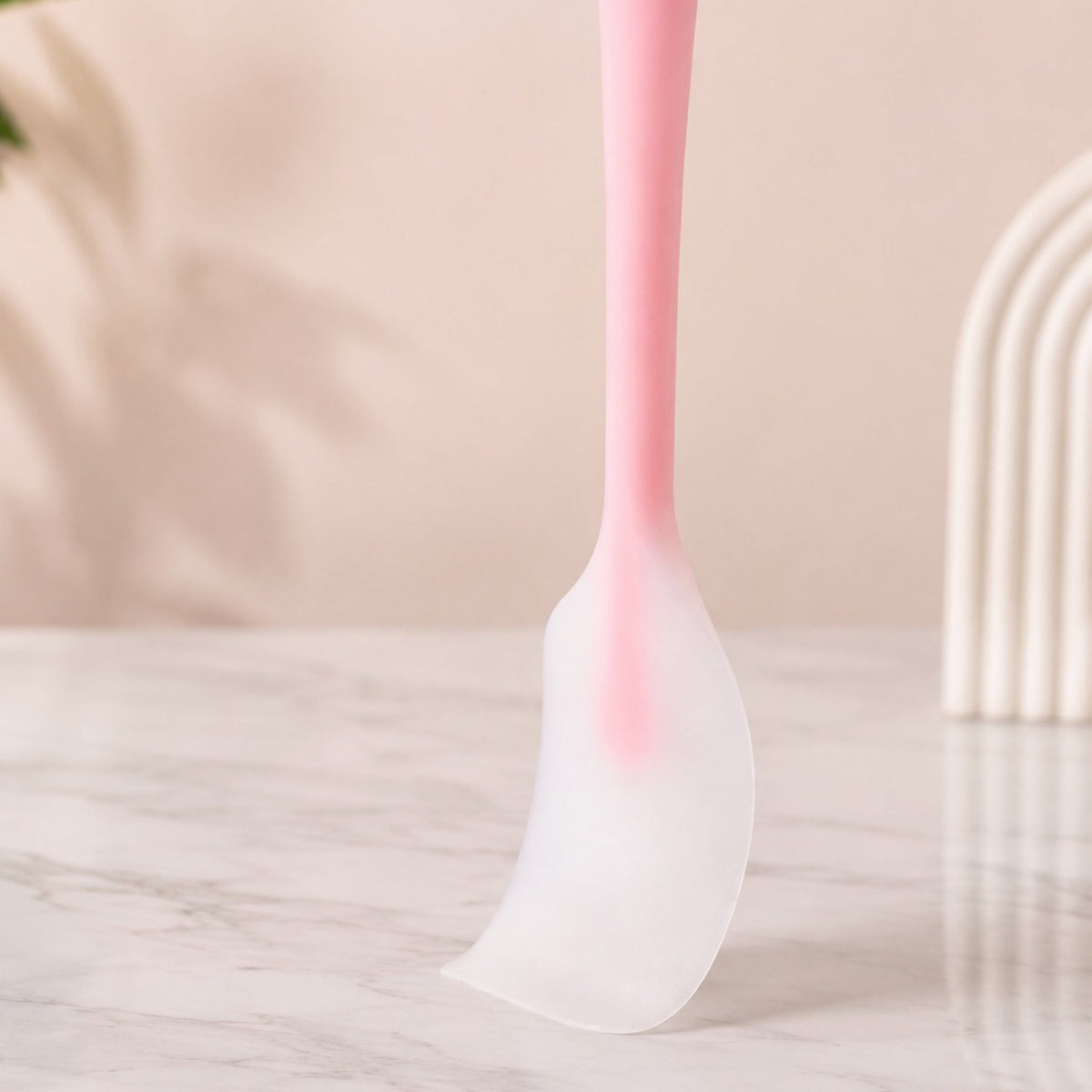 Pink silicone spatula flexible edge close-up
