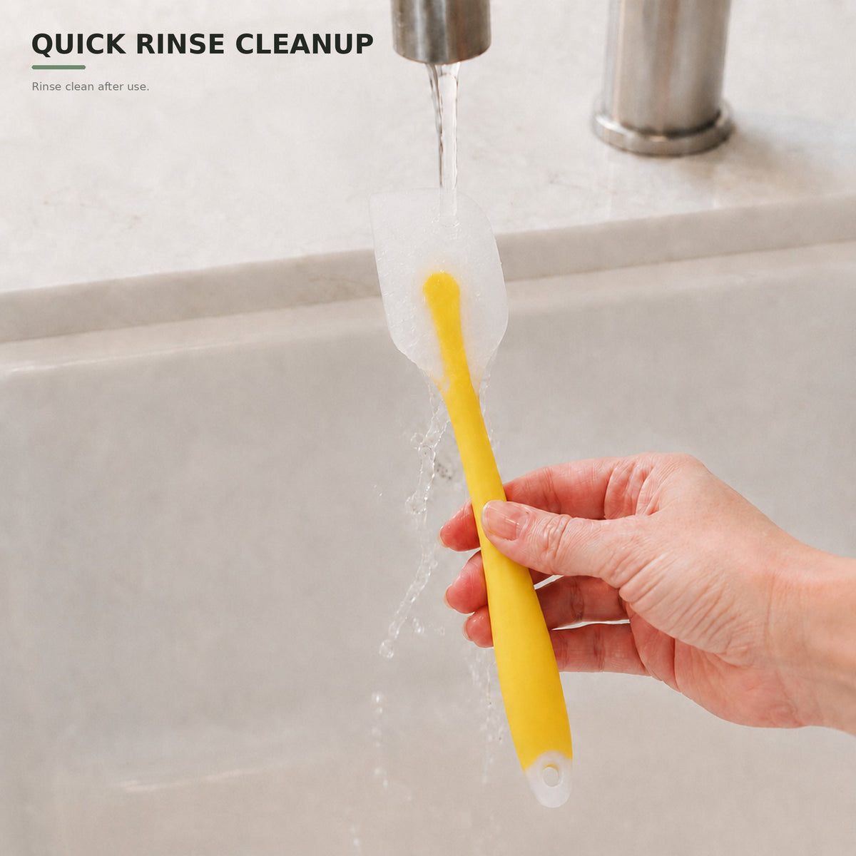 Yellow silicone spatula rinsed under running water